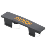 A black polypropylene keycap with the word FRENCH in yellow uppercase letters printed on top. Designed as a name tag for keyboards, it features clips underneath. The keycap is dishwasher safe and set against a plain white background.