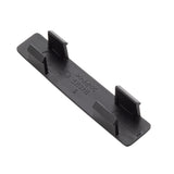 A black, rectangular polypropylene clip with four vertical tabs—two on each long side. Smooth surface features molded text, arrows, material type, and name tag symbols. The object is photographed on a white background and is dishwasher safe.