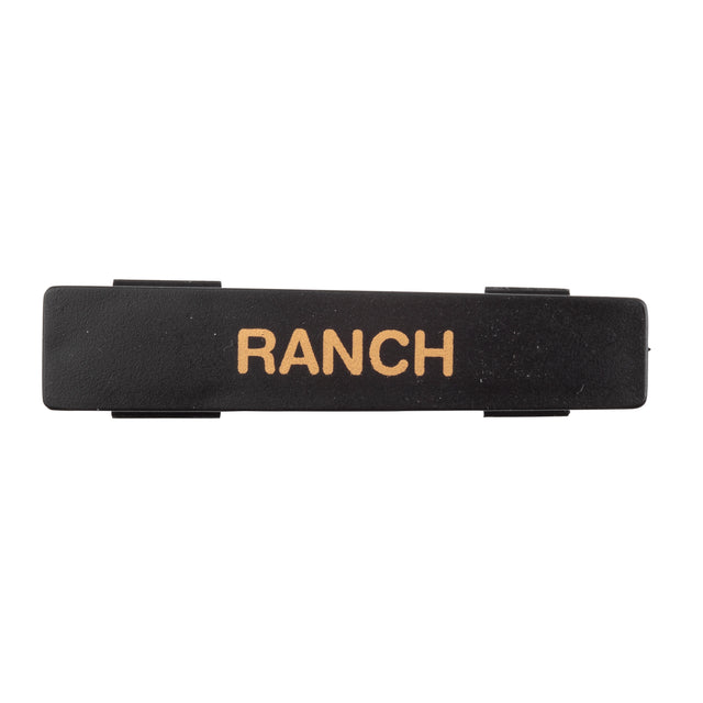 A black rectangular Ranch name tag label with the word RANCH in bold, uppercase, tan letters. Made from dishwasher safe polypropylene, it has clips or tabs on each side and is set against a plain white background.