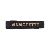 A black rectangular TableCraft name tag features the word VINAIGRETTE in bold, uppercase, gold letters centered on it. The label has small, raised tabs on its top and bottom edges against a plain white background.