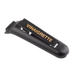 A black plastic TableCraft clip labeled VINAIGRETTE in gold letters rests against a white background. This sturdy name tag features a slightly rounded shape and a flat gripping surface where the text is displayed.