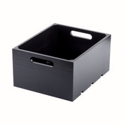 A sleek wood black crate with two cut-out handles on the shorter sides. This display crate features a smooth finish, modern design, and is photographed on a white background to showcase its empty interior.