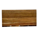 A rectangular wooden cutting board with a smooth finish and visible natural wood grain patterns in various shades of brown, reminiscent of an acacia wood crate. The board is positioned horizontally on a plain white background.