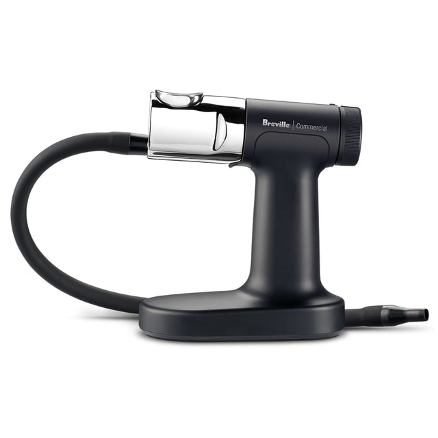 A sleek, black Breville Commercial smoking gun pro with a chrome chamber and flexible black hose rests on a sturdy base. This handheld cold smoke infuser is designed for adding smoky flavors to food and drinks.