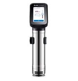 A stainless steel Breville Commercial Sous Vide Immersion Circulator with a digital display shows cooking settings, including “Breville Commercial” at the top and a 100-minute timer. The device stands upright on a white background.