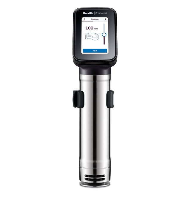 A stainless steel Breville Commercial Sous Vide Immersion Circulator with a digital display shows cooking settings, including “Breville Commercial” at the top and a 100-minute timer. The device stands upright on a white background.