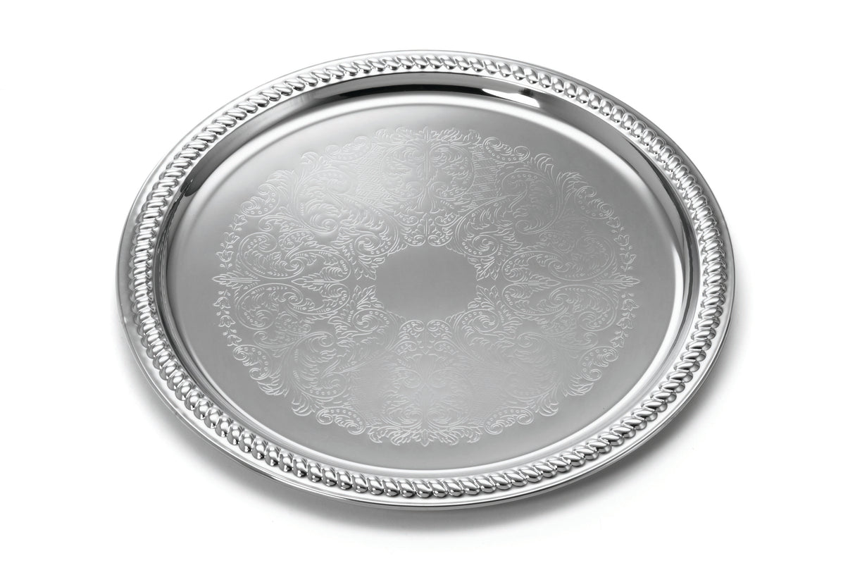 A 13 inch chrome plated serving tray with an ornate braided border. The flat surface features intricate, engraved floral and scrollwork patterns, giving it an elegant, decorative appearance and a shiny, reflective finish.