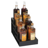 Eight assorted syrup bottles, arranged in two rows on a black polystyrene display stand. This countertop bottle organizer features three steps, holding each bottle securely with labels and pump dispensers, showcasing syrups from amber to dark brown.