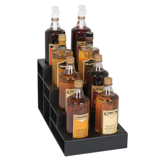 Eight assorted syrup bottles, arranged in two rows on a black polystyrene display stand. This countertop bottle organizer features three steps, holding each bottle securely with labels and pump dispensers, showcasing syrups from amber to dark brown.
