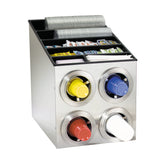 A stainless steel cup dispenser holds four stacks of cups in red, yellow, blue, and white. The top section features compartments with lids, straws, napkins, and assorted condiment packets, keeping everything neat and self-service ready.