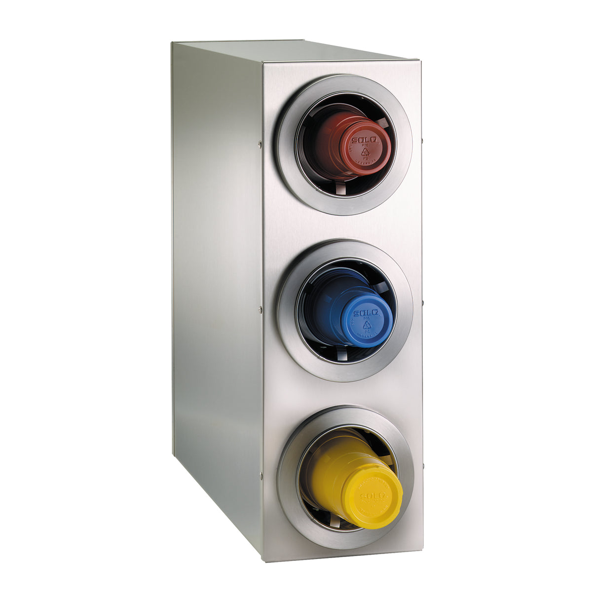 A stainless steel cup dispenser with three circular openings, each holding a colored plastic cup lid—red on top, blue in the middle, yellow at the bottom. The adjustable cup dispenser is angled to the left against a white background.