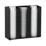 A black, three-compartment plastic dispenser serves as a practical countertop portion cup organizer, holding tightly packed stacks of clear cups facing upward. The simple design ensures organized and efficient cup storage.