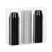 A clear acrylic countertop organizer holds three vertical stacks of disposable cups: two stacks of black plastic cups on the left and right, and one stack of translucent, textured plastic cups in the center. The holder is rectangular with open top and front.