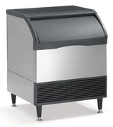 A commercial undercounter ice maker with a stainless steel body, black top, and black front panel. It features a large, curved door for accessing ice and four sturdy legs. The air-cooled ice maker has ventilation slats at the front bottom section.