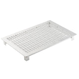 A silver, rectangular stainless steel rack with evenly spaced, rounded rectangular slots and four short legs at each corner. The rack is angled slightly, showing its flat surface and perforated cold food template design against a plain white background.