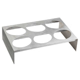 A stainless steel taco holder from TableCraft Products with six circular cutouts, designed to hold tacos upright. Its angled, rectangular structure features two legs for stability, and the brushed metal finish adds a sleek touch to any table setting.