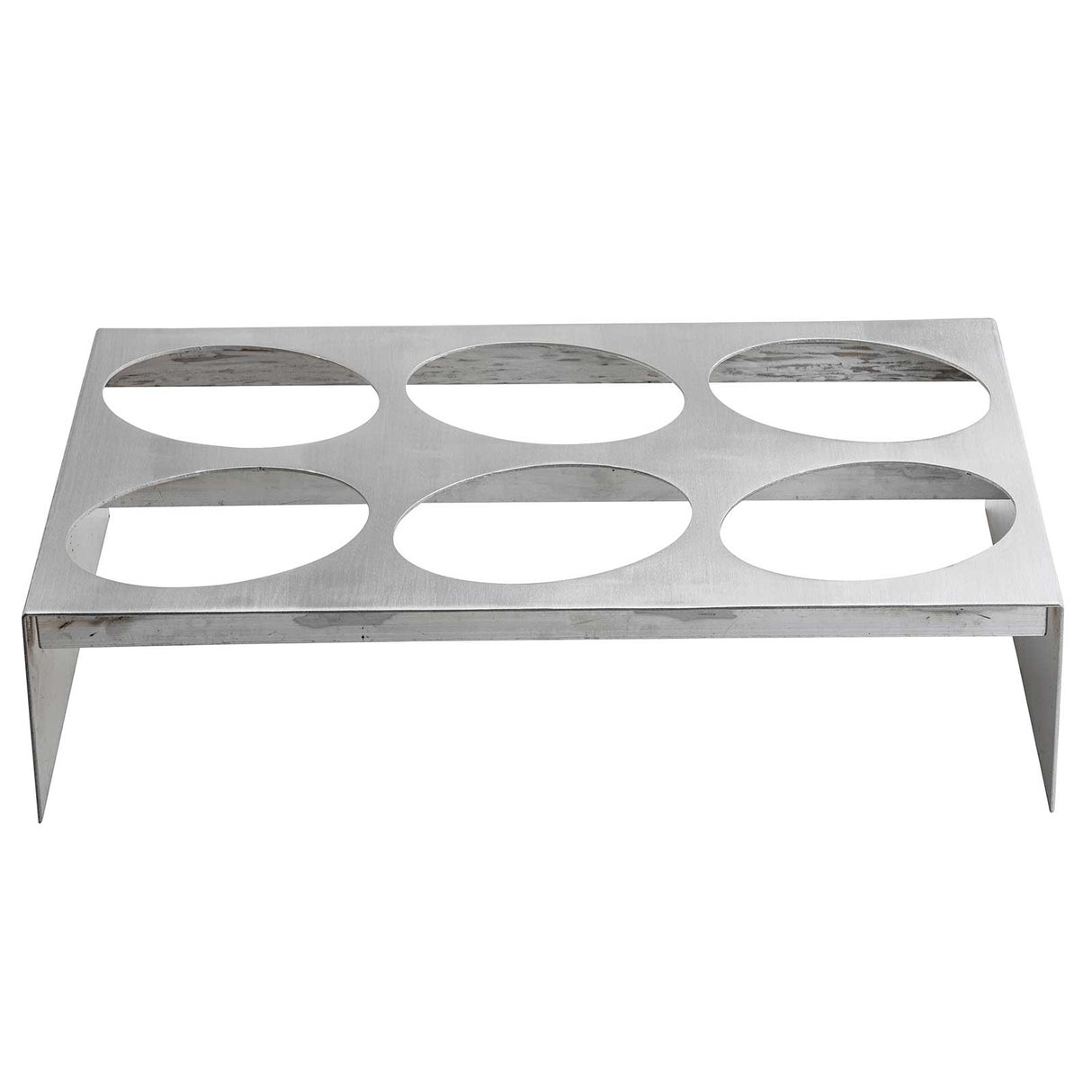 A rectangular nylon coated cast aluminum rack with six large circular cutouts in two rows of three, this TableCraft Products piece stands on four short legs with a brushed, reflective finish—ideal for holding bottles or glasses.
