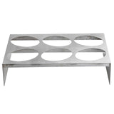 A rectangular nylon coated cast aluminum rack with six large circular cutouts in two rows of three, this TableCraft Products piece stands on four short legs with a brushed, reflective finish—ideal for holding bottles or glasses.