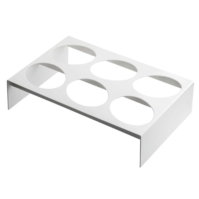 A white, rectangular TableCraft rack made of nylon coated cast aluminum features six large circular cutouts in two rows of three. The short vertical sides elevate it above the ground, making it ideal as a dressing template or for holding round containers.