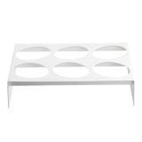 A white metal rack with holes, crafted by TableCraft, features a durable nylon coated cast aluminum design.