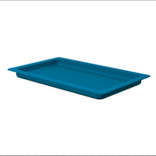 A rectangular, shallow, blue plastic tray with a ribbed bottom and wide flanged edges, shown on a white background. The tray is empty and positioned at a slight angle, highlighting its dishwasher safe design and interior texture.