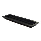 A rectangular, black cast aluminum tray with a shallow depth and grid-like pattern on the bottom, viewed from a slight angle. The tray has a wide rim and a small, raised compartment in one corner. The background is completely white.