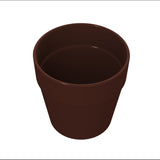 A plain, empty brown flowerpot is shown against a white background. Reminiscent of a cast aluminum condiment crock, the pot has smooth sides, a slightly wider rim at the top, and no markings or decorations. It’s viewed from above at a slight angle.