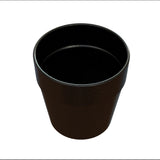 A black, empty, round plastic plant pot with a slightly flared rim is shown from an angled top-down view against a white background. The pot’s surface has small white speckles, giving it a textured appearance and is dishwasher safe for easy cleaning.