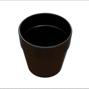 A black, empty, round plastic plant pot with a slightly flared rim is shown from an angled top-down view against a white background. The pot’s surface has small white speckles, giving it a textured appearance and is dishwasher safe for easy cleaning.
