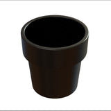 A simple, black, cylindrical plastic flower pot with a slightly wider rim at the top. Similar to a condiment crock in size, it appears empty against a plain white background. Small, subtle speckles are visible on the surface of the pot.