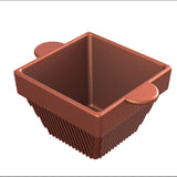 A 3D-rendered, square-shaped brown cast aluminum container with vertical ridges on the sides and two rounded tabs on opposite edges. The container is empty and positioned against a white background, viewed from an angled top-down perspective.