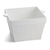 A white, square ceramic baking dish with vertical ridges and two small handles sits on a plain white background. The dish has a glossy finish, a slightly flared rim, and is ideal for cold holding or serving as a stylish condiment bowl.