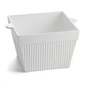 A white, square ceramic baking dish with vertical ridges and two small handles sits on a plain white background. The dish has a glossy finish, a slightly flared rim, and is ideal for cold holding or serving as a stylish condiment bowl.