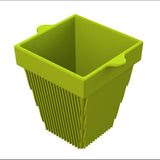 A green, square-shaped plastic basket with vertical slits on the sides is perfect for cold holding. The tapered base, smooth surfaces, and small handle tabs make it a practical choice for organizing items or pairing with a condiment bowl.