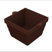 A brown, square-shaped silicone baking mold with ribbed sides and two small handles on opposite edges. The mold, shown empty against a white background, offers versatility much like a cold holding bowl for your baking needs.