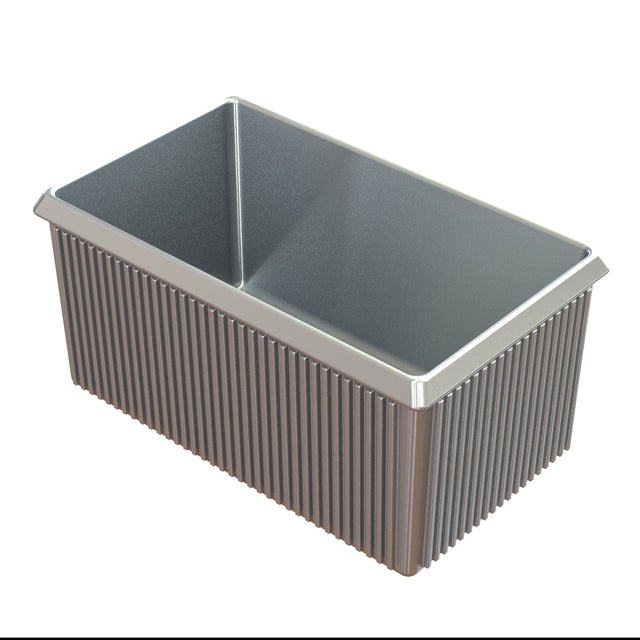 A rectangular cast aluminum loaf pan with a nonstick interior and textured, vertically ridged sides and exterior. The pan has straight edges and slightly flared top rims, photographed on a white background.
