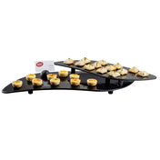 A two-tiered, black Duracoat coated cast aluminum serving tray holds mini quiches below and folded pastry appetizers above. A small white card with a red logo sits at the back. The NSF trays are elevated on short black legs.