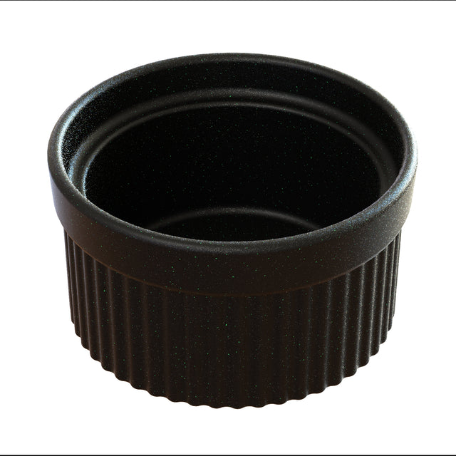 A black, round souffle bowl with a smooth interior and a ridged exterior. This ceramic ramekin is dishwasher safe and shown empty against a white background, with its open top facing upward.