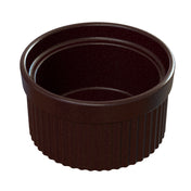 A small, round, dark brown ceramic souffle bowl with ribbed sides and a smooth, glossy interior. The dish is empty and sits on a plain white background.