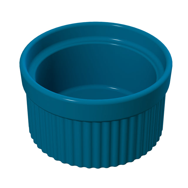 A glossy, deep blue Souffle Bowl with a smooth interior and ribbed exterior stands empty against a white background. The round bowl features thick walls, a slightly flared rim, and is dishwasher safe for easy cleaning.