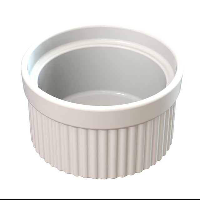 A white ceramic souffle bowl with a smooth interior and ribbed exterior sits on a white background. The round, empty ramekin is shown from a slightly elevated angle, ideal for cold holding desserts or appetizers.