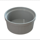 A white, round ceramic Souffle Bowl with vertical ridges along the sides and a smooth, glossy interior, shown empty against a plain white background—ideal for baking or cold holding your favorite dishes.
