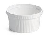 A white ceramic souffle bowl with a smooth interior and vertically ribbed exterior sits on a white surface. This small, round dish has a slightly flared rim and is ideal for baking or serving individual portions of food.