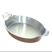 A shiny, oval-shaped cast aluminum au gratin baking dish with two small, textured handles on each end, set against a white background. Its smooth sides and reflective surface give it a polished, modern appearance.