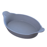 A gray oval cast aluminum baking dish with two small handles featuring subtle ridged patterns. Ideal for Au Gratin dishes, it has smooth, rounded edges and a simple, unadorned design. The plain white background highlights its elegance.