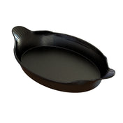 A black, oval-shaped roasting pan with a speckled finish and two small, textured handles on each end. Made of cast aluminum, the pan features a slightly glossy interior surface, ideal for baking, roasting, or preparing Au Gratin dishes.