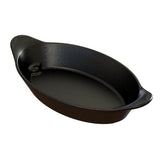 An oval-shaped, black roasting pan with a speckled finish and two small handles on each end. This dishwasher safe server features a glossy surface; the ridged handles offer better grip. The pan appears empty and clean.