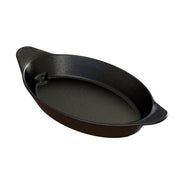 A black, oval-shaped Duracoat coated cast aluminum baking dish with a speckled pattern sits on a white background. The dish is dishwasher safe and has two small textured handles for grip. Its inner surface is smooth and slightly reflective.