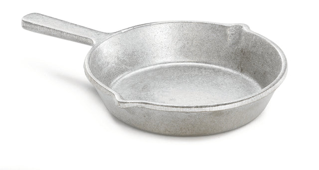 A plain, silver cast aluminum fry pan with a short handle and two small pouring spouts sits on a white background. The skillet's surface is rough and uncoated, and the handle is solid with no grip or hole for hanging.