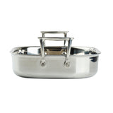 A shiny tri-ply stainless steel roasting pan is shown from the front. It has two sturdy rectangular handles and a wide, shallow design with a flat bottom, ideal for roasting. The pan is induction oven safe. The background is plain white.